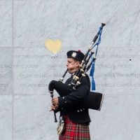 EQM Photo of memorial with bagpipe player 22022017